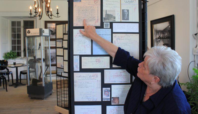 Nancy Gray Lachaîne showing some of the 4000 historical documents and pieces in the exhibit.