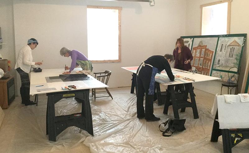 Volunteers recreating “Community Patchwork” mural in Vankleek Hill