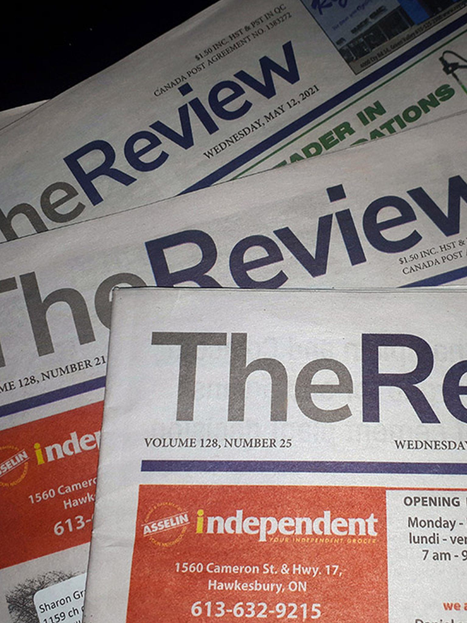 This is a photo of a stack of The Review Paper Newspapers